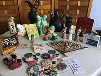 Full view of assorted collectibles including planters, decanter, figurines, pins, and bobbleheads