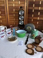 Full view of the collection showing Pyrex bowl, weather station, mugs, tin, coasters, candlestick, decorative bowl, and letter opener.
