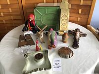 Front view of lot items including bread tin, puppets, figurines, vases, crucifix, and misc.