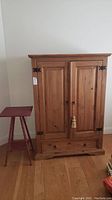 Armoire and side table together, showing full front view and relative size