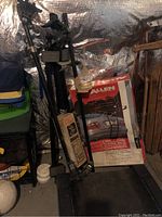 Four racks stacked and boxed in a basement area including bike racks, roof rack, and ski rack.