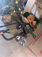 Full lot view showing hedge trimmer, planter pots, birdfeeders, and fountain pump.