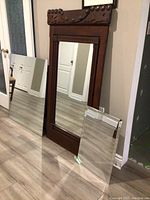 All three mirrors displayed together showing size differences: large vintage wood framed mirror, medium frameless mirror, small beveled edge mirror with chip.