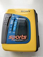 Front side of the yellow and gray Sony Sports Walkman showing model WM-FS191 with FM/AM frequency scale and 'Sports Walkman' branding.