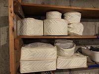 Quilted zip-up fabric storage cases stacked on wooden shelves