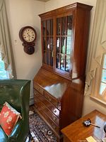 Full frontal view of the hutch mounted on the secretary desk showing glass doors, drop-front surface and lower drawers.
