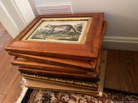 Stack of wooden framed wall art prints showing the sides and layers of the frames