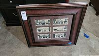 Full view of one framed replica Texas currency print showing six different currency note replicas.