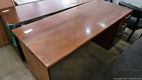Full view of the top and side of the large laminate executive desk.