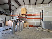 Overview of assembled shelving showing orange beams and grey uprights