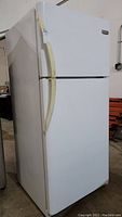 Full view of the white Frigidaire refrigerator showing exterior condition and overall size.