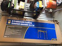 Unopened cardboard box with Power Fist branding and scaffold illustration, showing external damage