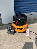 Front view of compressor with hose and manual laid out