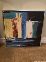 Frontal image showing the full framed abstract painting with colors and design visible.