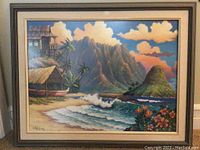 Full view of the framed art showing scenic Hawaiian landscape with ocean waves, mountains, hut, and tropical foliage under a cloud-filled sky.