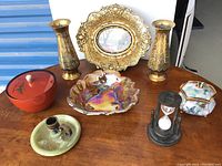 Overview of all decorative items on wooden table showing variety and condition