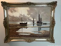 Front view of framed painting showing sailboat scene and ornate gold frame