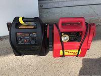 Photo of Motomaster Eliminator 400A and Car Start 2000 portable jump start systems placed side by side on concrete ground.