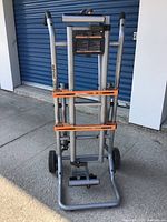 Folded stand front view showing full frame, mounting brackets and wheels