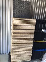 Stack of approximately 56 panels showing overall quantity and used condition