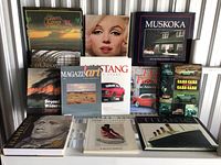 Photo of 12 assorted books arranged in two rows showing cover art and titles