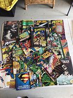 Top-down view of entire lot of comic books spread out on floor showing multiple superhero titles and Star Trek comics