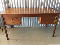 Front view of teak wood desk with two drawers each side