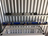 Three levels displayed horizontally: black torpedo level, blue torpedo level with orange end caps, metal Mark-IT Johnson level.