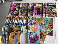 Photo showing assorted Marvel and DC comics including Fantastic Four, Spider-Man, Wonder Woman, Dennis the Menace, Star Wars Return of the Jedi, and more.