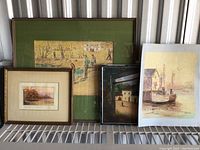 Four framed art prints displayed together showing various rustic and landscape scenes. Frames are visibly scratched and worn.