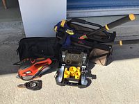 Group photo showing all the tools and bags arranged on concrete surface.