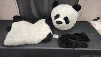 Full view of panda head, body suit and cooling vest laid out on table