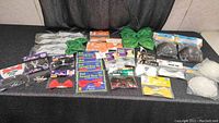 Overview of assorted packaged and loose bow ties along with some bikini tops