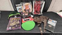 Full view showing all costume accessory items including elf shoes, gloves, hat, masks and stockings.