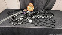 Plastic Halloween chains with large circular shackles and two black whips with handles