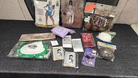 Overview of ladies costumes and accessories including hosiery, nurse apron, and raccoon hat