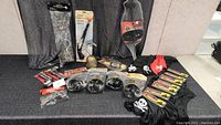 Wide view of various pirate costume accessories including gloves, scarves, hooks, belts, and bandanas.