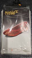 Photo of sealed Spirit Halloween packaging showing ruby red glittery slippers image on front with size options.
