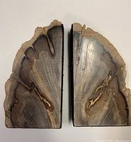 Pair of oak wood bookends viewed from the top, showing natural wood grain and rough natural edges.