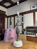 Full view of the Art Deco lady statue lamp without the light bulb on top.