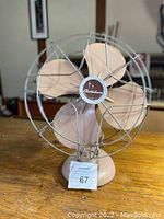 Front view of the Electrohome vintage table fan, showing metal blades, protective wire cage, and base.