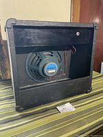 Rear view of the Behringer amplifier cabinet showing the mounted 10" Jensen speaker with wiring.