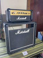 Full view of Marshall Valvestate 10 amp head placed on top of Marshall speaker cabinet with visible Marshall branding on both