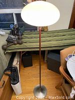 Full view of lamp showing frosted glass shade, rosewood stem, cast metal base