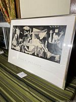 Angled view of framed Guernica poster print showing overall condition and frame profile.