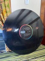 front view of black 34" diameter disc with center label visible