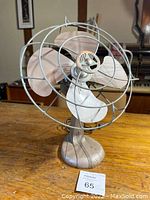 Front and angled view of the vintage Silex Handy Breeze electric fan showing its metal blade and cage.