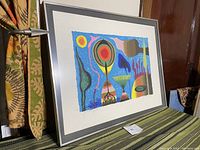 Framed abstract lithograph print in a room setting showing size and framing details.