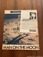 Front cover of the 'Man on the Moon' newspaper insert showing an astronaut on the moon surface and the title text.