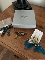 Set with box, headband, barrette, and earrings on wooden surface